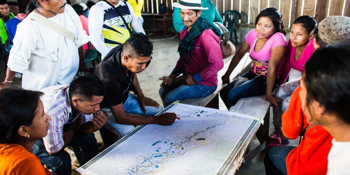 Members of indigenous community in Caqueta, Colombia work on a community map